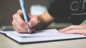 Design an image featuring a hand holding a pen