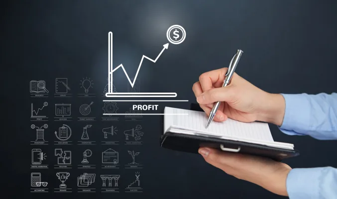 hand holding a pen, writing on a postcard, with financial symbols